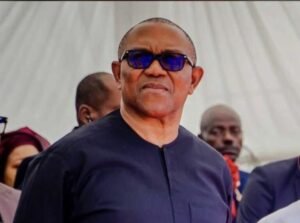 Peter Obi speaking during a live session with supporters, wearing a traditional black outfit and gesturing passionately.