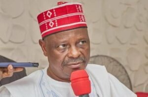 Kwankwaso wearing his signature red cap and traditional attire during a public appearance.