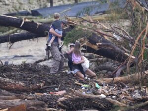 A man rescues children from floodwaters in Texas after devastating flash floods.