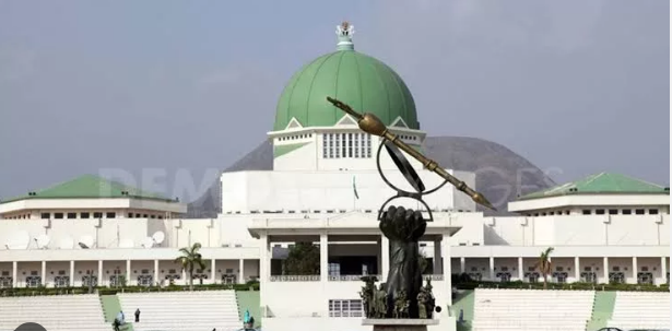 National assembly Front view of Nigeria’s National Assembly complex in Abuja with the green dome and the prominent legislative mace sculpture in the foreground.
