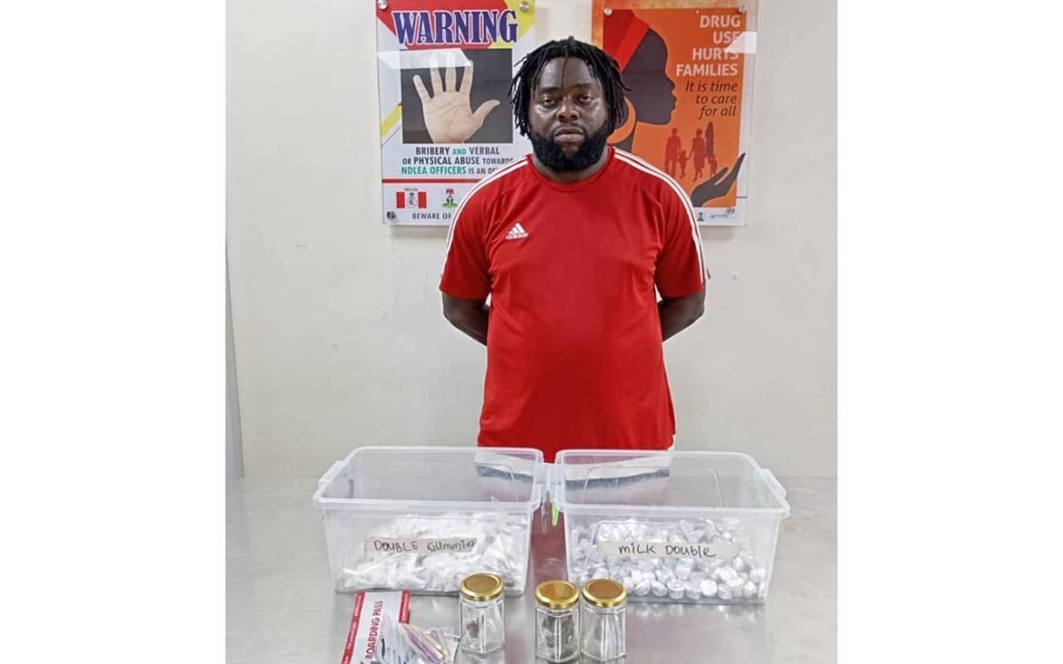 NDLEA NDLEA arrests suspect with drug consignments including gummies and other substances displayed on a table.