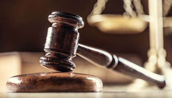 Drama in court A courtroom scene where a notorious cult leader makes a shocking confession, leaving people in shock and silence.