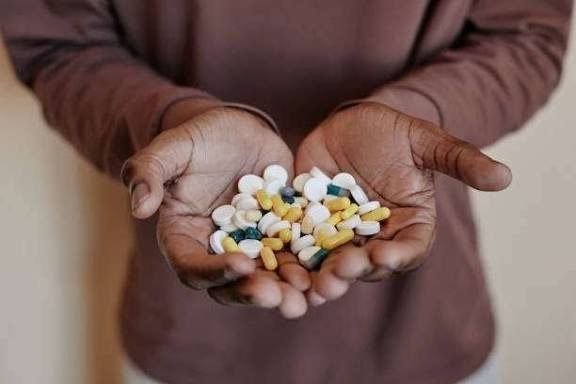 Pain killers A group of Nigerian youths sitting together, some looking weak and tired, symbolizing the growing addiction to painkillers.