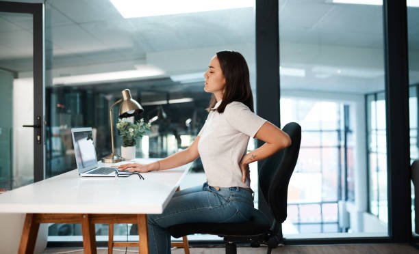 Office tips An office worker sitting for long hours at a desk with a worried look, symbolizing the health dangers of too much sitting.
