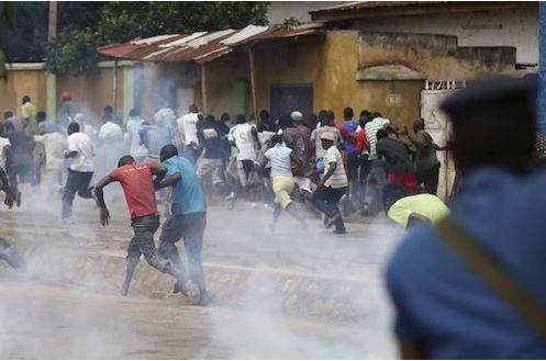 Cult clash A chaotic scene at a Port Harcourt market after a deadly cult clash, with people running for safety and shops abandoned.