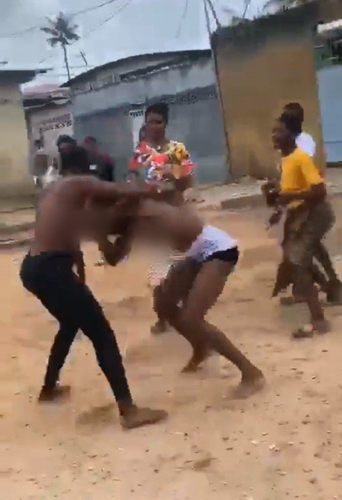 Two ladies fights over a man Two angry ladies fighting in public after discovering they are dating the same man.