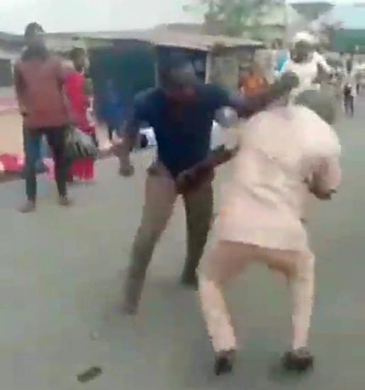 Two-grown-men-fight-over-a-woman-in-the-middle-of-a-street-in-Nigeria-video-scaled-1 Two angry young men fighting after discovering they were dating the same girl.