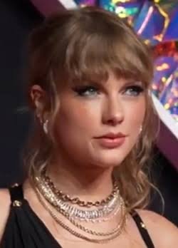 Taylor swift Taylor Swift smiles during an interview as she reacts to rumors about quitting music after marrying Travis Kelce.