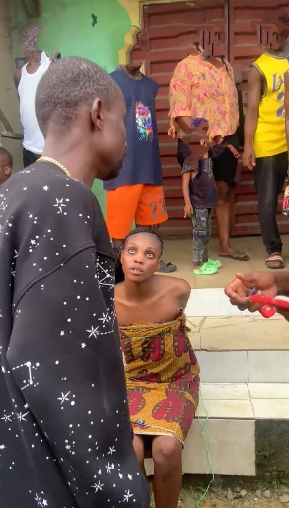 A confused young girl being assisted by residents after she suddenly ran mad on Amechi Street in Port Harcourt.