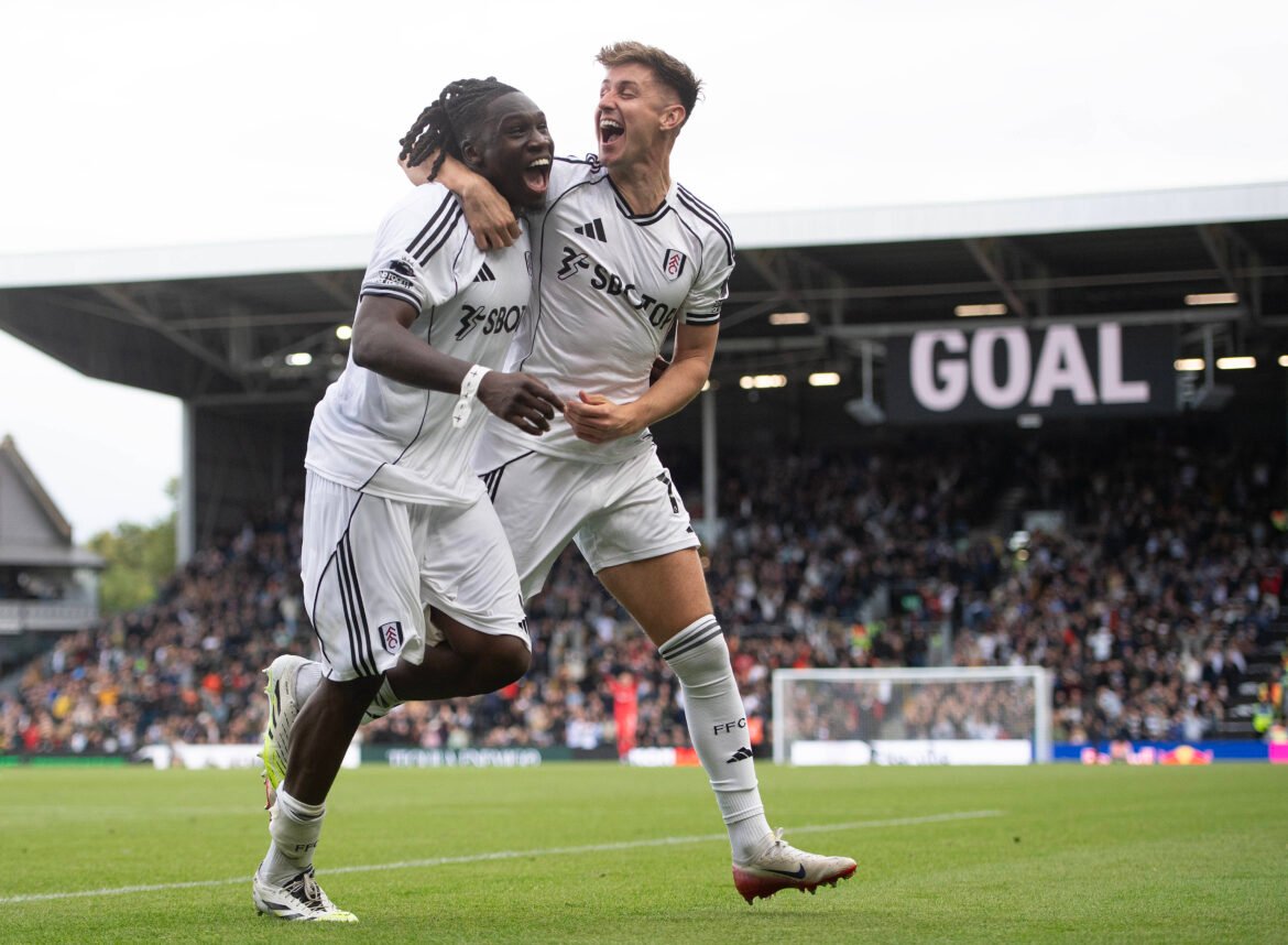 Fulham players Calvin Bassey and Tom Cairney share a light moment after Cairney signs a new contract, highlighting friendly banter between teammates.